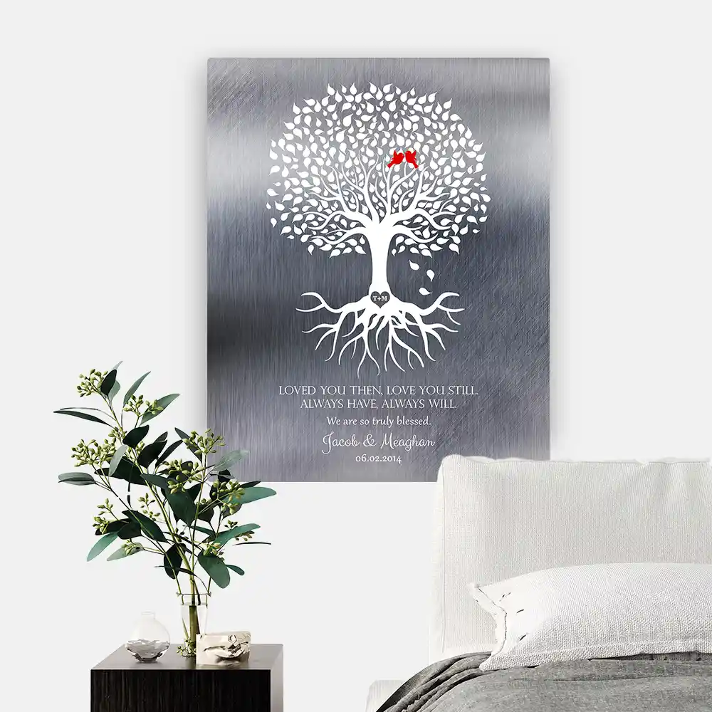 10 Year Anniversary wall plaque hanging on wall beside bed in primary bedroom. White tree with expansive canopy and roots on tin metal plaque.