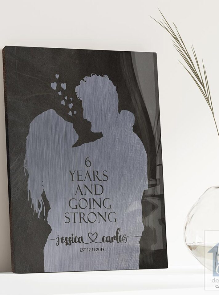 Relocation concept. A smiling cheerful multiracial couple in embraces lookin in each other eyes Relocation concept. A smiling cheerful multiracial couple in embraces lookin in each other eyes